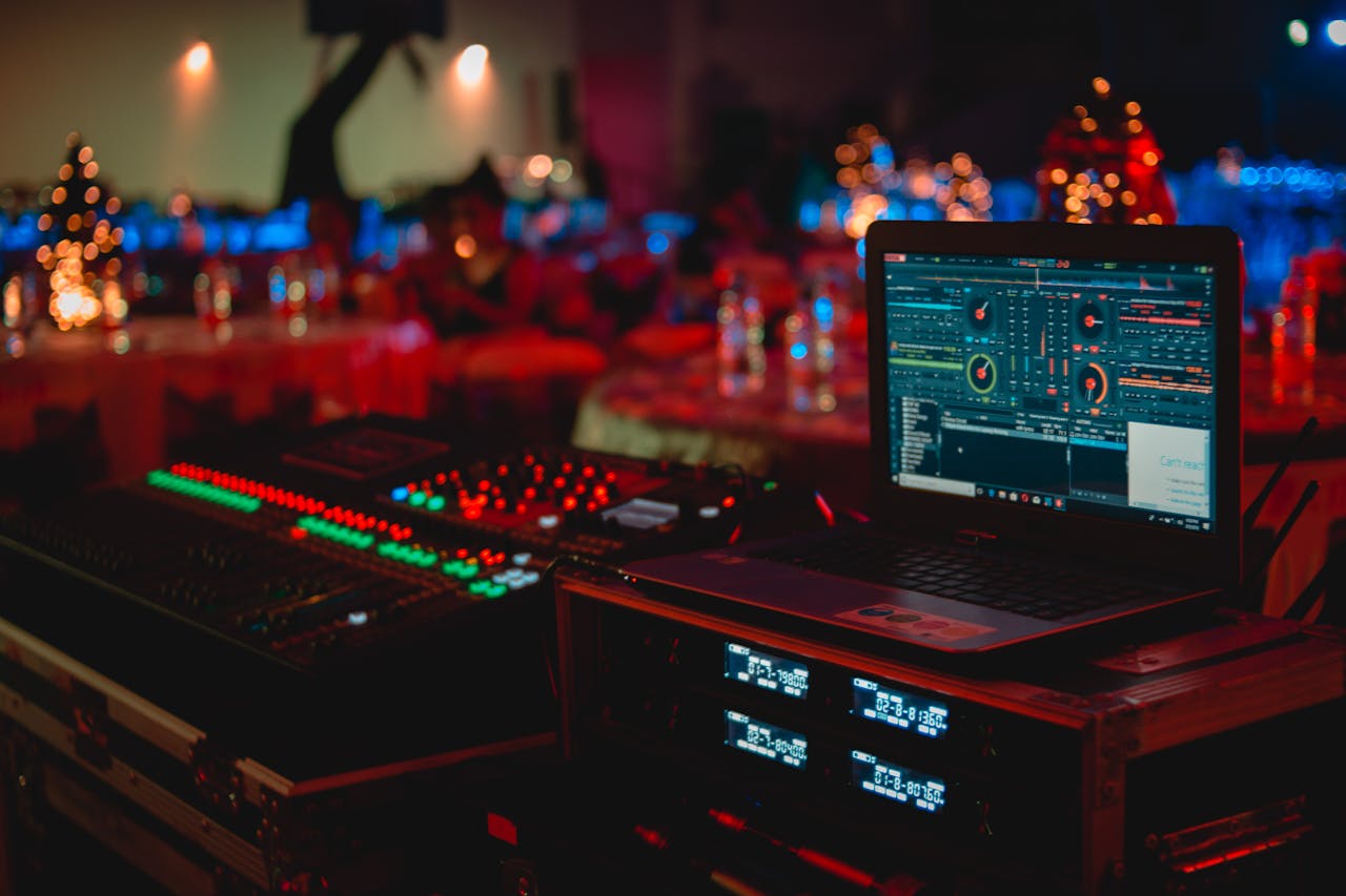 image showing different DJ controls and equipment in a dark room