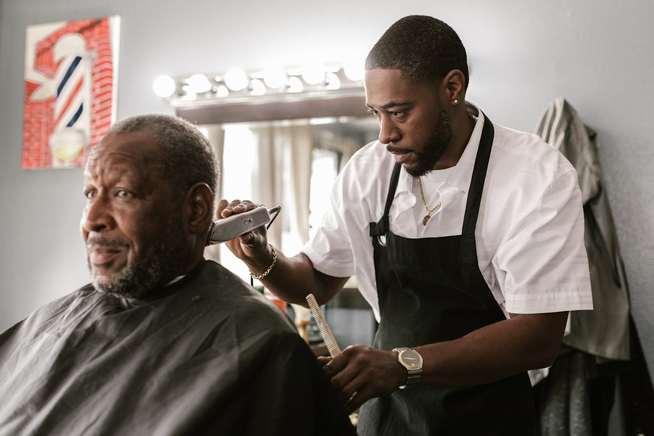man having a hair cut in a barber shop